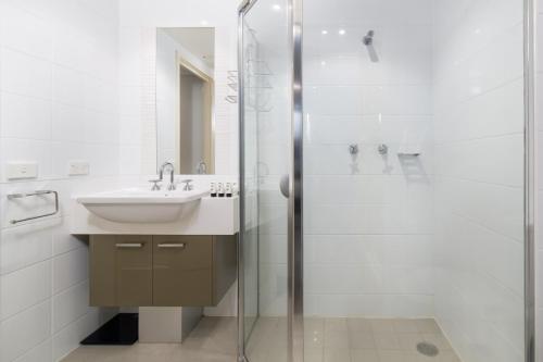 a bathroom with a sink and a shower at Central 1-Bed with Parking BBQ and Indoor Pool in Canberra
