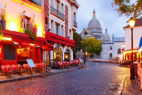 a cobblestone street with tables and chairs on a street at Chambre Arena Porte La Chapelle in Paris