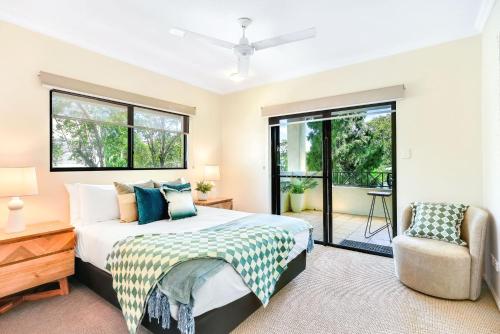 um quarto com uma cama grande e uma cadeira em Central Park em Cairns North