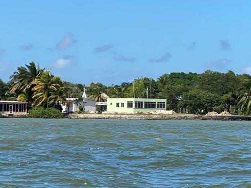 a house on an island in the water at Tranquil Waterfront Escape in Orange Walk