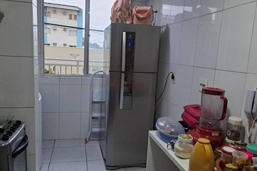 a kitchen with a stainless steel refrigerator in a room at Apartamento na Ponta Negra, 2 quartos, sendo uma suite in Manaus