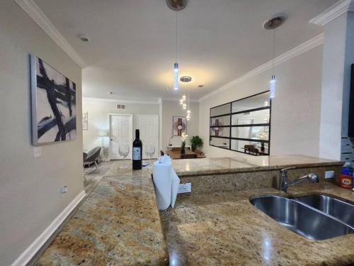 a kitchen with a sink and a bottle of wine at Relax and indulge in luxury! in Kissimmee