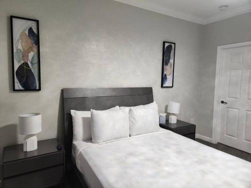 a bedroom with a large bed with two nightstands and two lamps at Relax and indulge in luxury! in Kissimmee