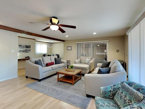 a living room with two couches and a ceiling fan at The Crows Nest in Ruidoso