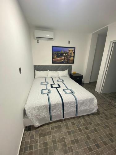a bedroom with a large bed in a room at Blue Inn Hotel & Suites in Mazatlán