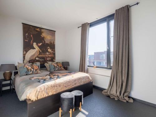 a bedroom with a large bed and a large window at Modern Ninety-One in Berghem