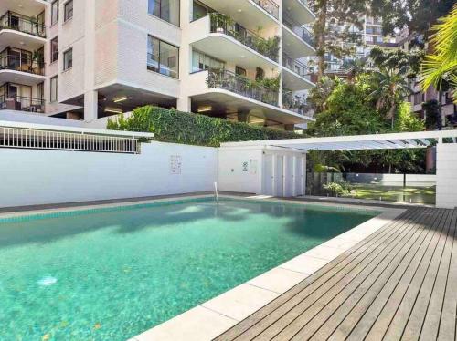 a swimming pool in front of a apartment building at Elizabeth Bay Marina Apartment in Sydney