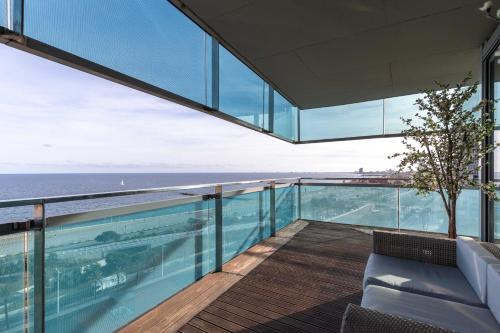 a view of the ocean from the balcony of a house at Luxury Apartment With Sea View! in Barcelona
