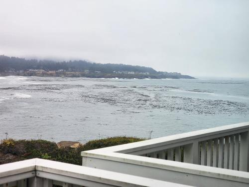a view of the ocean from the balcony of a house at Inn at Arch Rock in Depoe Bay