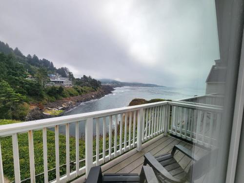 a balcony with a view of a river at Inn at Arch Rock in Depoe Bay