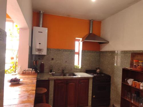 a kitchen with a sink and a stove at VelayWasi in Humahuaca