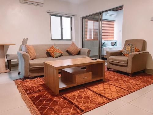 a living room with a couch and a coffee table at Sky Suites East Legon in Accra