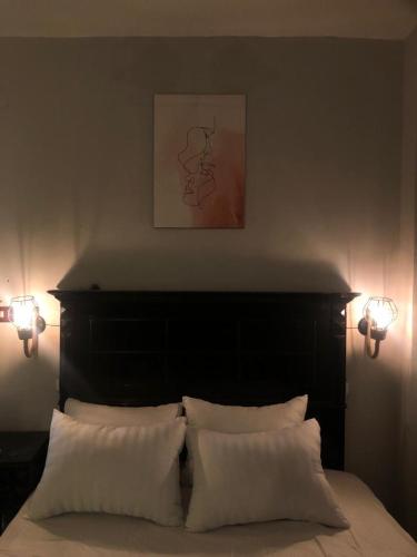 a bedroom with a bed with two white pillows at AL DOKI COMFORT ROOM - Males only in Cairo