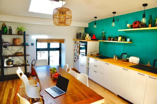 a kitchen with a wooden table with a laptop on it at Lovely townhouse Bordeaux in Bordeaux