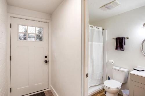 a white bathroom with a toilet and a shower at Studio w/ King Bed near Dwtn in Rochester