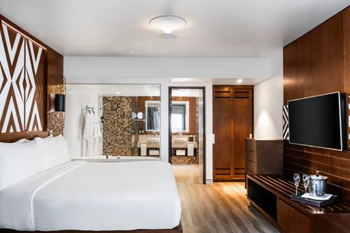 a bedroom with a large white bed and a television at Crowne Plaza Fiji Nadi Bay Resort & Spa by IHG in Nadi