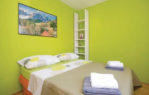 um quarto com uma cama grande e paredes verdes em Apartments with a swimming pool Kastel Stafilic, Kastela - 22569 em Kaštel Novi