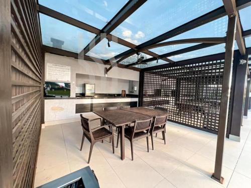 a dining room with a table and chairs on a patio at PRAIA BRAVA AP Mobiliado Condominio COMPLETO in Itajaí