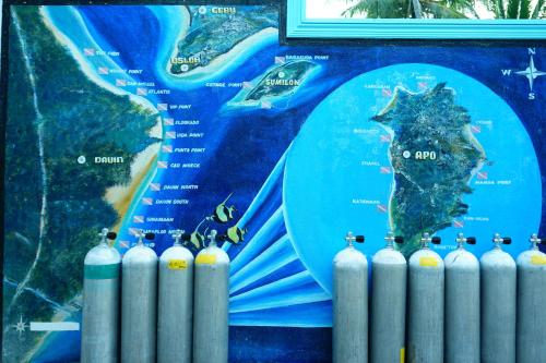 a wall with a map of the ocean and a group of oxygeninatedinatedinated at 囍潜Side Effects Dive Resort Dauin in Dauin