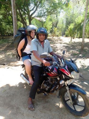 a man and woman sitting on a motorcycle at Peacock Residence & Cabana's in Tangalle