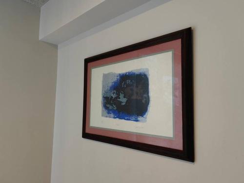 a picture hanging on a wall in a room at 804 SECRT Sabana Hermoso Apartamento con Aire Acondicionado in San José