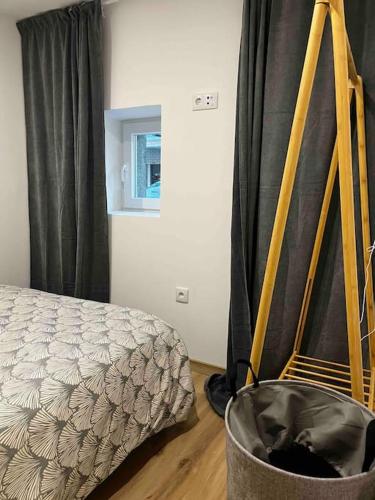 a bedroom with a bed and a black curtain at Flat da Kaká in Maia