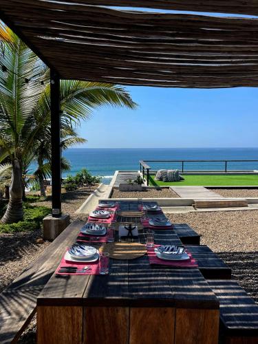 a table with plates of food on top of the beach at casaNorte paraíso norteño mirador de Ballenas in Canoas De Punta Sal