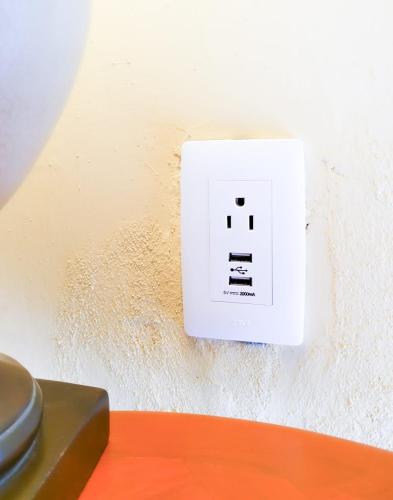a white switch on a wall next to a table at Estrellita's Bed & Breakfast in Ajijic