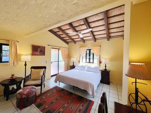 a bedroom with a bed and a chair at Estrellita's Bed & Breakfast in Ajijic