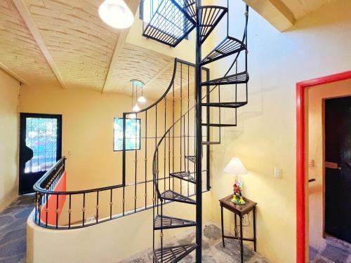 a spiral staircase in a room with a lamp at Estrellita's Bed & Breakfast in Ajijic