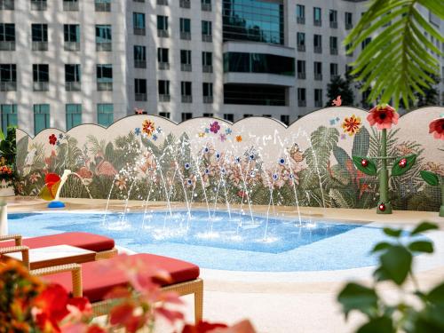 a fountain in the middle of a city with buildings at Island Shangri-La, Hong Kong in Hong Kong