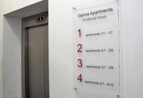 a wall with a sign on the side of a door at Spacious flat next to central station in Glasgow