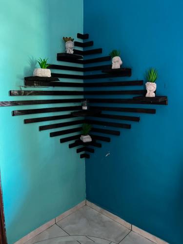 a blue wall with a staircase with potted plants at Casa de Emilia in Santa Ana