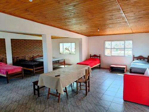 una habitación con 2 camas y una mesa en una habitación en Doña Guada, en Humahuaca