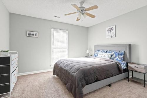 a bedroom with a bed and a ceiling fan at Renovated 3BR Retreat with Large Patio & Grill in Charlotte