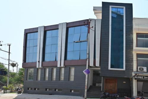 a building with a lot of windows on a street at Hotel Navraj Palace in Gomti Nagar