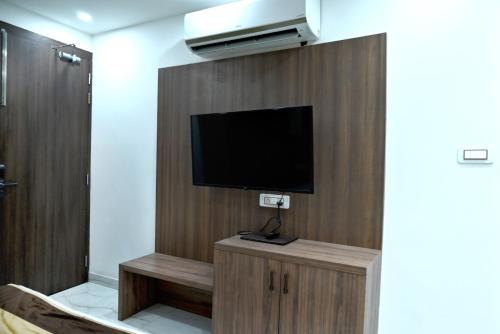 a room with a flat screen tv on a wall at Hotel Navraj Palace in Gomti Nagar