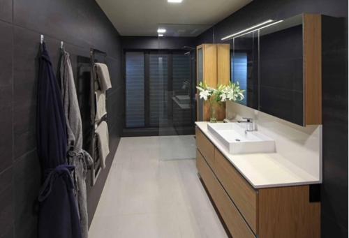 a bathroom with a sink and a mirror at Taonga with Sea Views by Waiheke Unlimited in Oneroa