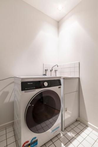 a washing machine in a kitchen with a sink at 2-Bedroom Apartment in Melbourne City with carpark in Melbourne