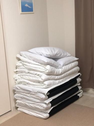 a stack of white towels stacked on top of each other at Apartment Heights HANA in Sakai