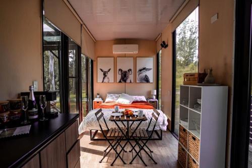 a bedroom with a bed and a table in a room at River's Edge at The White House on Bowman in Barrington