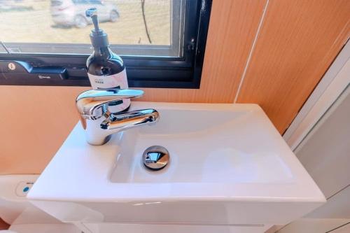 a white sink with a bottle on top of it at Hermano Farm Stay 
