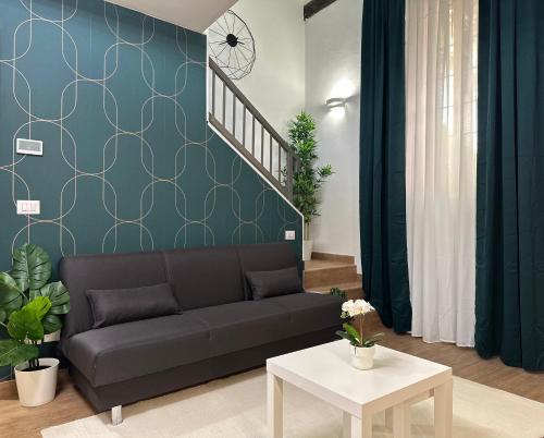 a living room with a couch and a table at Mascarella Boutique Apartment in Bologna