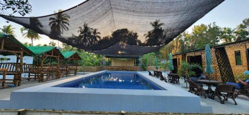 a large swimming pool with a net over it at 3S Farm and Resort in San Antonio