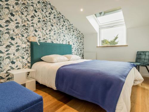 une chambre avec un lit avec une couverture bleue et une fenêtre dans l'établissement Charmant gîte indépendant avec terrasse, proche plage et golf, idéal pour des vacances à Pornic - FR-1-306-1267, à Pornic