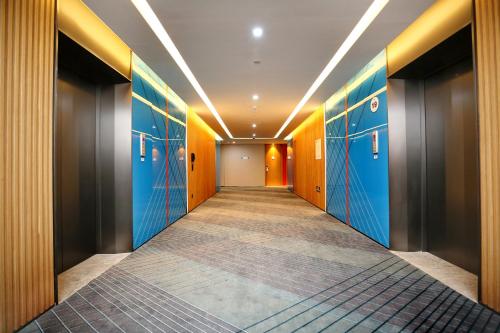 a hallway with blue lockers in a building at Holiday Inn Express Chengdu North Railway Station by IHG - Near Panda Base, Near Chunxi Road in Chengdu