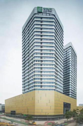 a tall building with a sign on top of it at Holiday Inn Express Chengdu North Railway Station by IHG - Near Panda Base, Near Chunxi Road in Chengdu