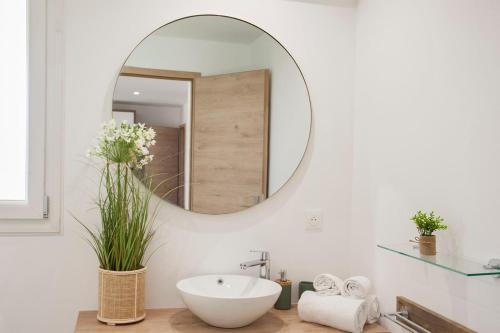 La salle de bains est pourvue d'un lavabo blanc et d'un miroir. dans l'établissement Villa Albizzia with terrace and garden 68 people, à Calvi