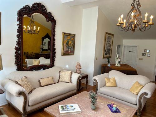 a living room with two couches and a mirror at Unwind Island 3 Bedrooms 3 full washrooms in West Palm Beach
