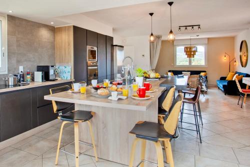 a kitchen with a large island in the middle of a room at Apartment "Jasmin" 3 bedrooms with large terrace 6 8 people in Calvi